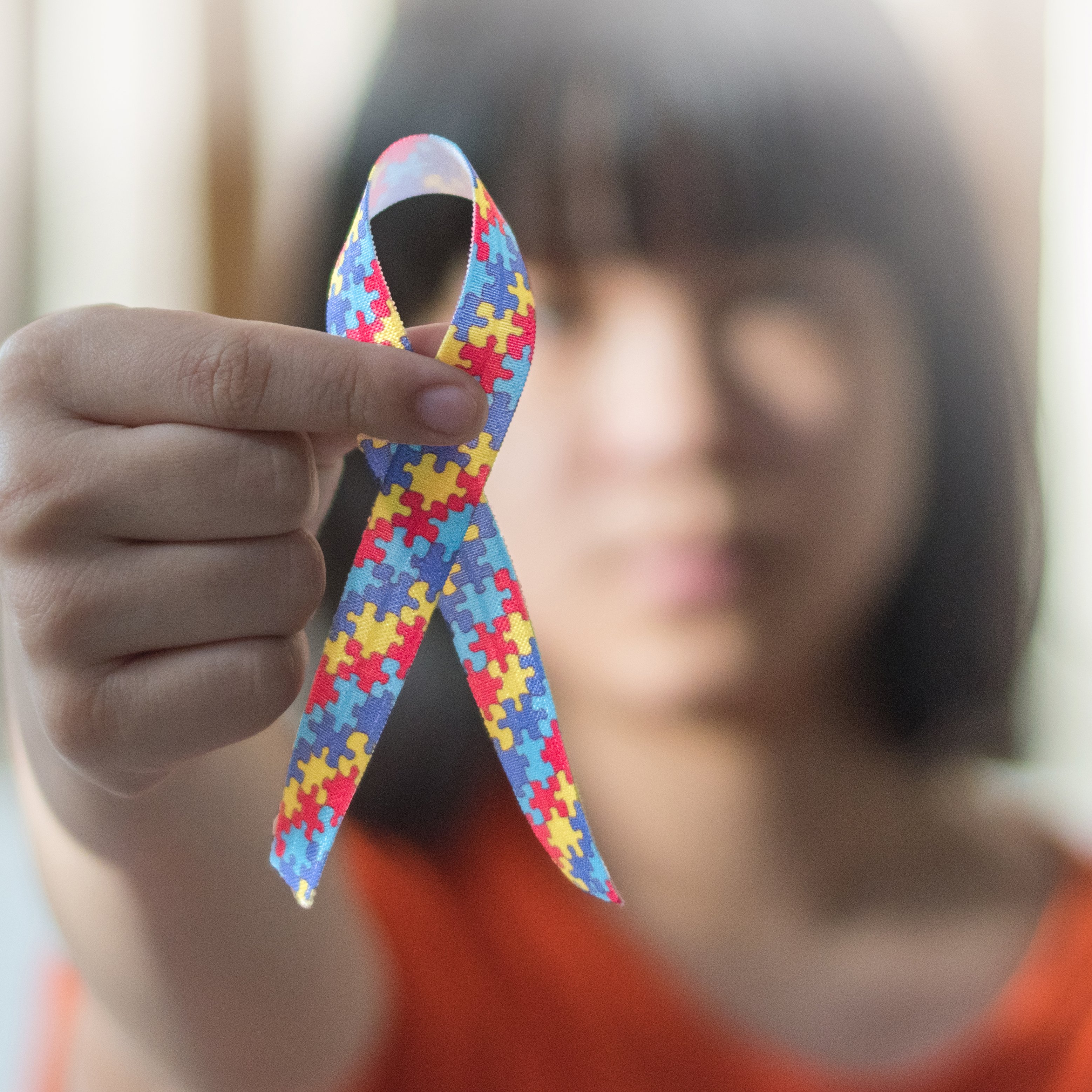 girl holding autism ribbon