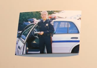 female-police-officer-by-police-car female-police-officer-by-police-car