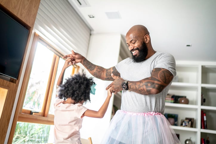 father and daughter with autism with tutu skirts dancing like ballerinas