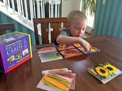 boy-using-language-builder-cards-pointing-to-banana-card