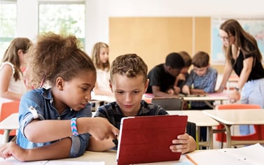 School kids with autism in class using a digital tablet