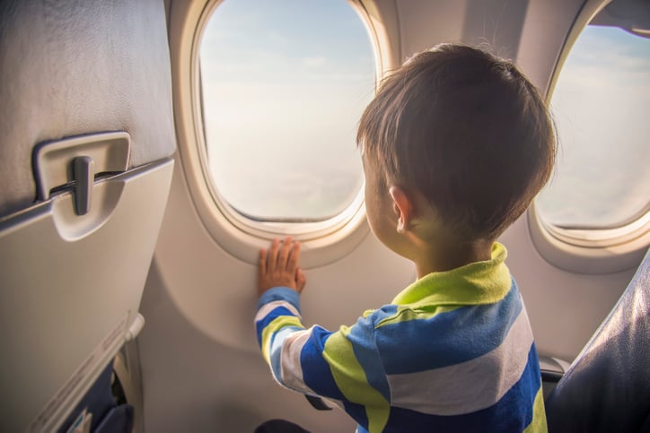 boy with autism looking out airplane window