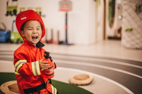 boy with autism pretending to be firefighter