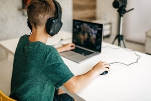 boy-playing-online-game-with-headphones
