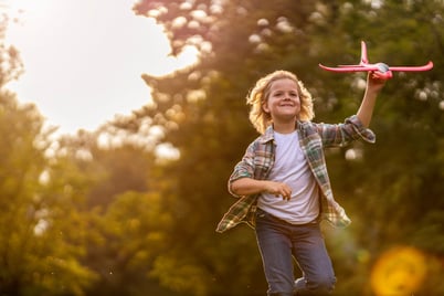 child with autism playing with toy airplane
