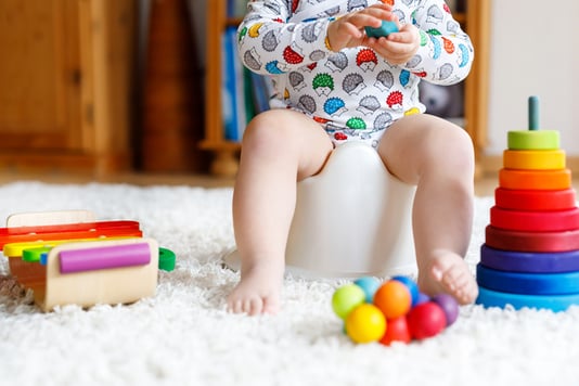 child with autism potty training with fidget toys