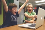 boy-and-girl-playing-excitedly-on-computer