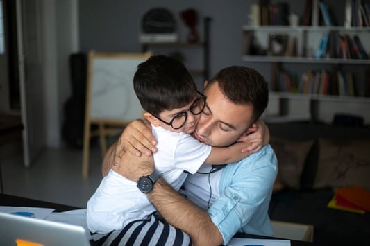 father and son with autism hugging