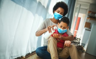 mom-putting-hand-sanitizer-on-son's-hands