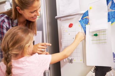 child-and-mom-using-stickers-to-track-rewards