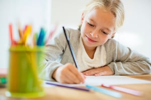 girl with autism writing on paper
