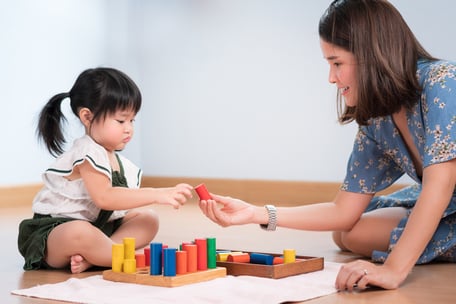 Asian mother teaching preschool daughter