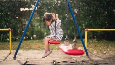 asian girl alone on a swing