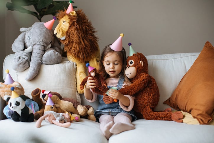 Girl with autism at party playing with her stuffed animals