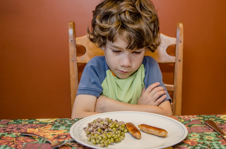 child with autism fussy at dinner table