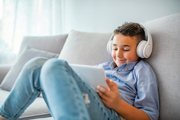 child with autism learning independently wearing headphones