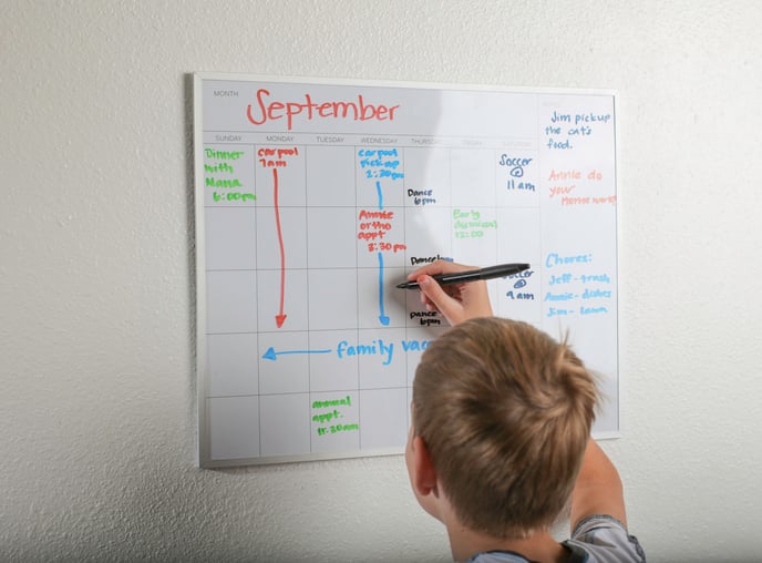 child with autism writing a schedule