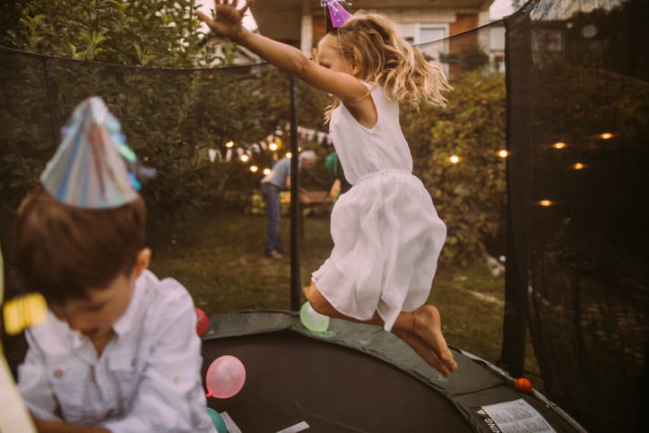 kids at birthday party jumping on trampoline