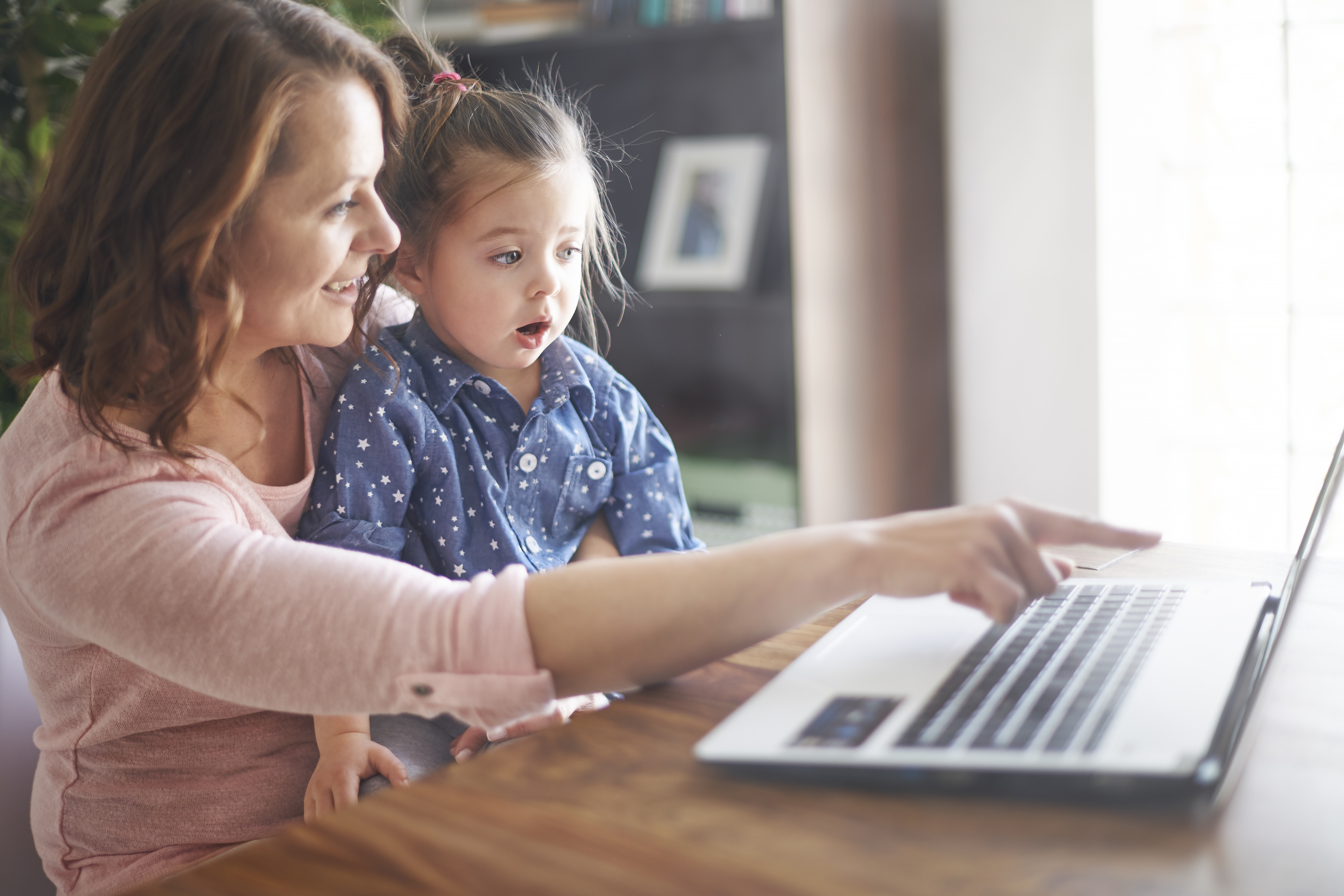 mother-daughter-watching-video-laptop