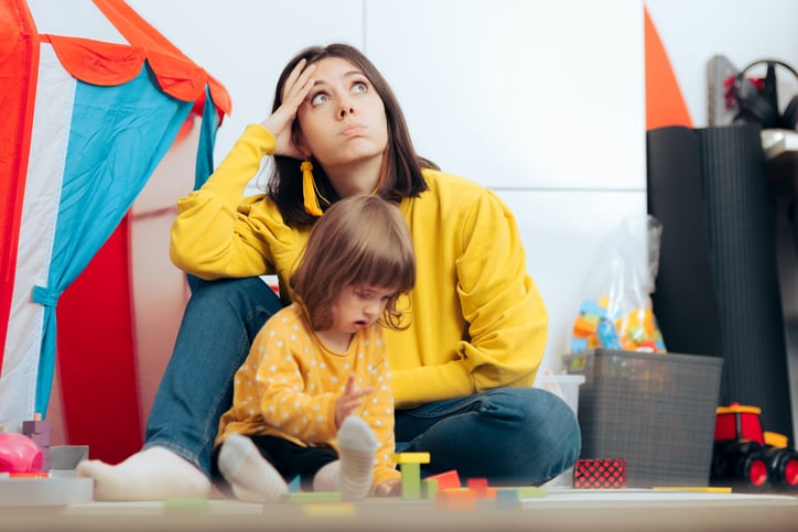 overwhelmed mom of child with autism thinking concerned being stressed and wondering about daily problems
