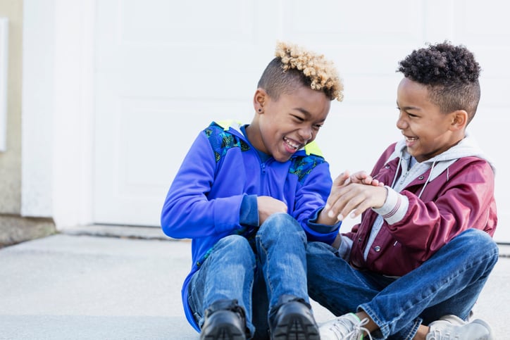 two friends with autism laughing