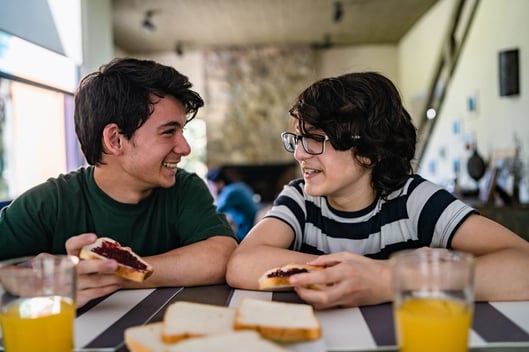 two teenagers with autism having lunch together