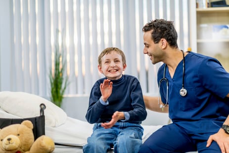 boy with autism interacting with male doctor