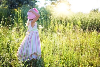 girl with autism in a grassy field 