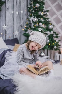 girl with autism reading a book over the holidays
