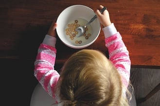 autistic girl holding cereal bowl 