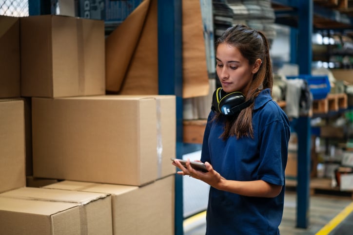Warehouse worker with autism updating the stock on mobile app