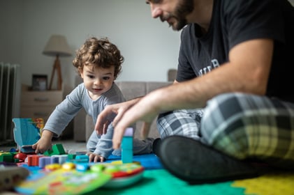 father and child with autism playing games